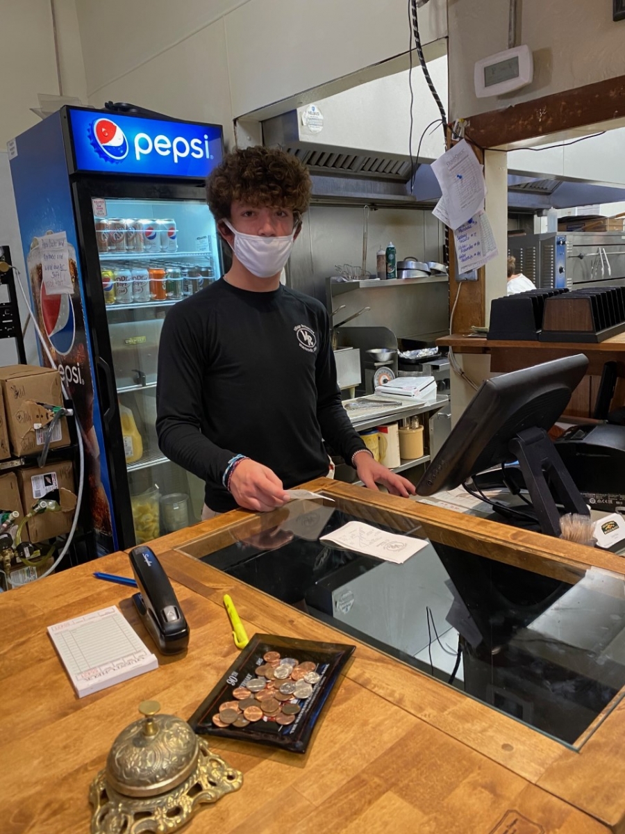 person standing behind a cash register